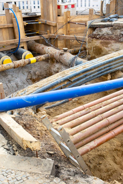istock Installation of district heating lines. Large open excavation site 2200661181