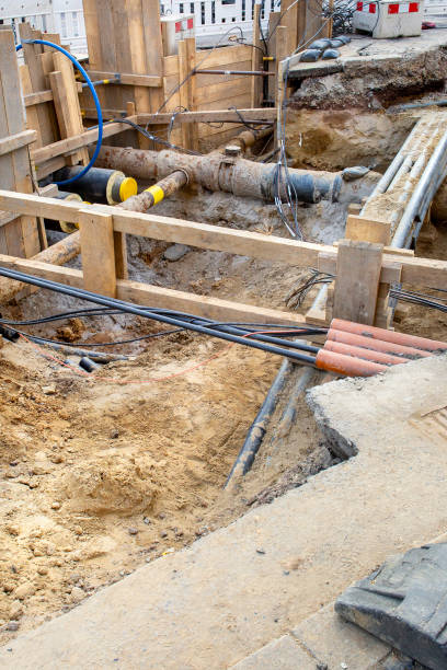 istock Installation of district heating lines. Large open excavation site 2200661205