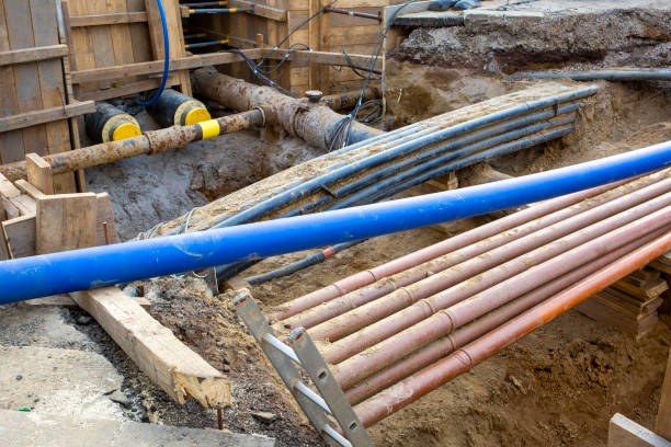 istock Installation of district heating lines. Large open excavation site 2200661242