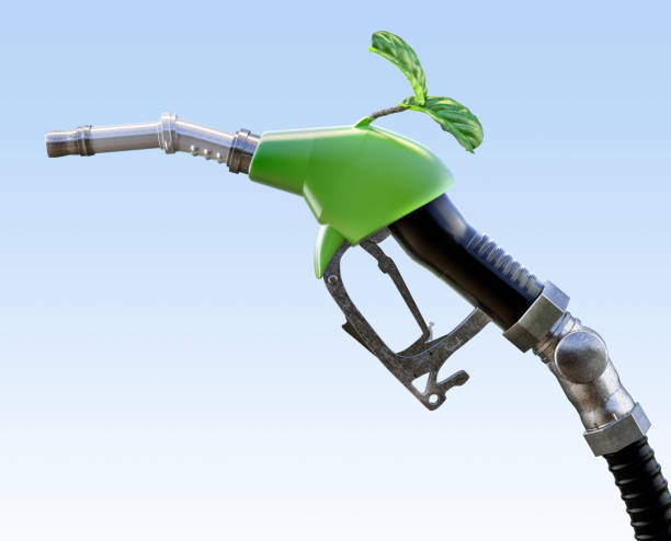 istock Green fuel pump nozzle with a small plant sprouting from it. 2200661259