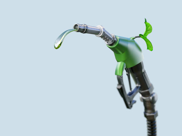 istock Green fuel pump nozzle with a small plant sprouting from it. 2200661269