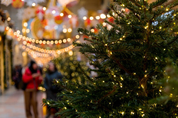 Festive holiday decorations with glowing lights and cheerful shoppers