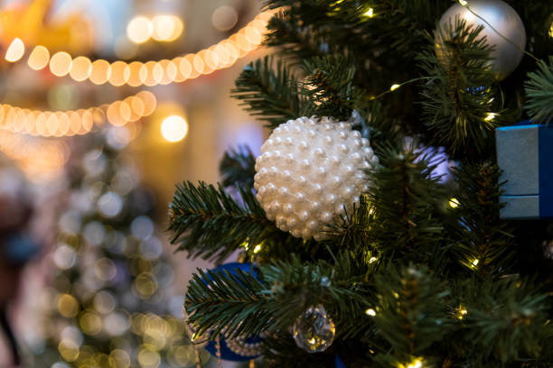 istock Decorated Christmas tree with bright lights and ornaments in festive setting 2200663318