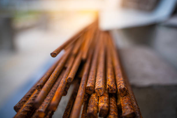 Rusty construction rebar close-up. Corrosion affects exposed metal outdoors.