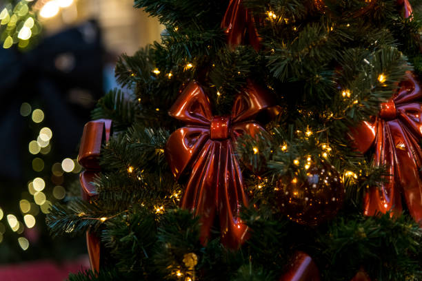 istock Christmas tree adorned with red bows and warm lights in festive atmosphere 2200668426