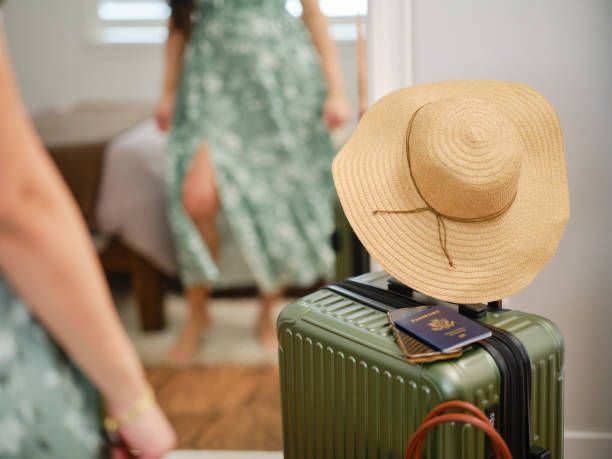 A hispanic woman in a home, preparing to leave for a vacation.