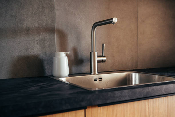 istock Water faucet and metallic sink in modern sleek kitchen 2200671215
