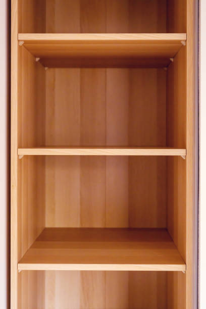 istock Simple minimalistic storage shelves made of wooden particleboard material, empty shelf as copy space 2200671295