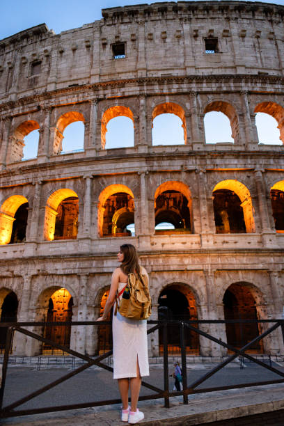 istock Woman with backpack standing in front of Coliseum in Rome 2200675424