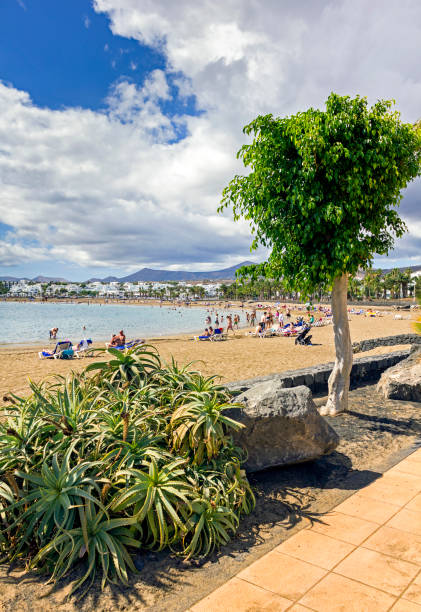 View across the beach at Puerto del Carmen Lanzarote, Spain.  People can be seen on the beach