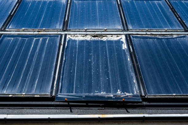 istock partly melted solar enegry accumulator on a roof.. 2200679763