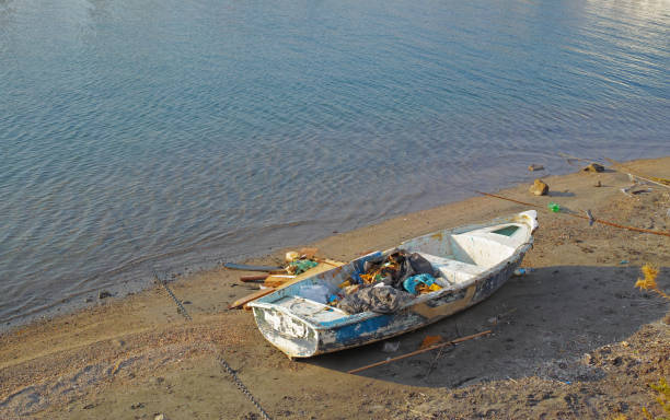 Wooden migrant boat shipwreck washed ashore after sea crossing