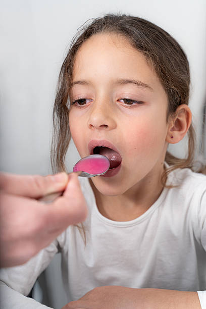 istock Girl taking her medicine 2200682232