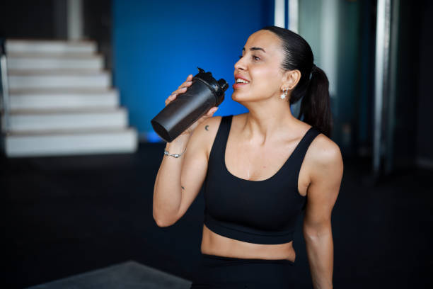 istock Woman at the gym drinking water 2200686709