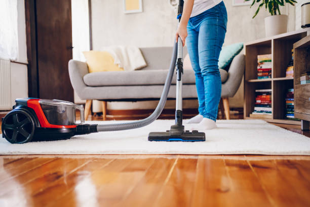 istock A woman cleans her home. Close up on vacuum 2200686868