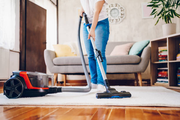 istock A woman cleans her home. Close up on vacuum 2200686957