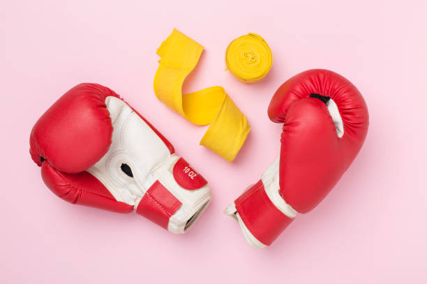 istock Red boxing gloves on color background, top view. 2200690456