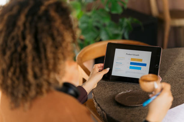 istock Businesswoman analyzing product growth on digital tablet in cafe 2200691588