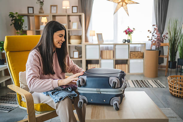 istock One woman pack suitcase baggage prepare for vacation holiday 2200692025