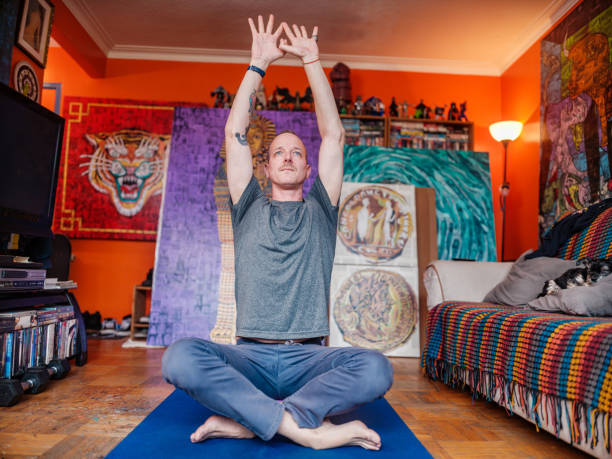 istock Mid adult male artist practising yoga at his studio 2200694607
