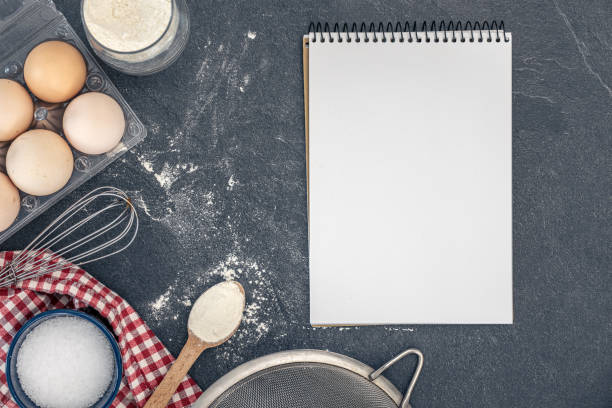 istock Background with baking ingredients and blank book. Baking ingredients. 2200696796