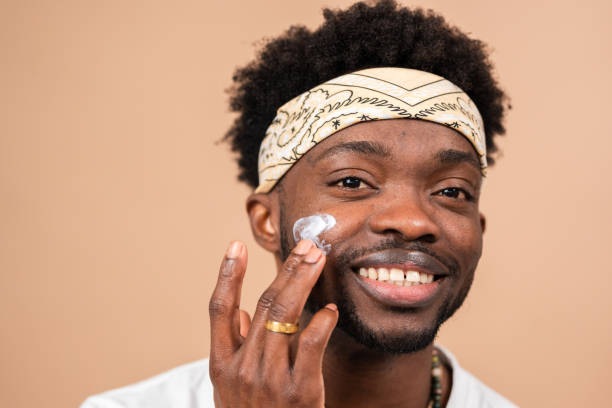 istock man applying moisturizer on face for skincare routine 2200696855