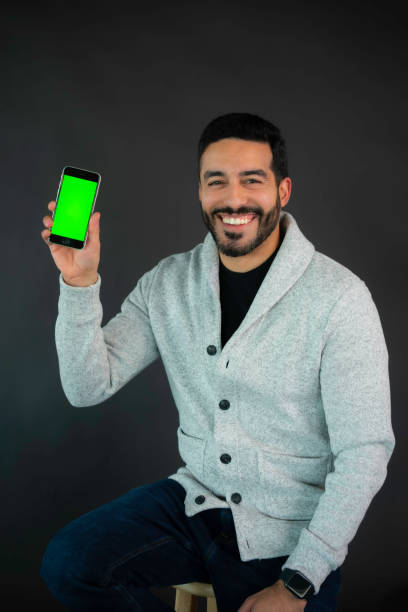 istock Man holds up smartphone showing the screen 2200699209