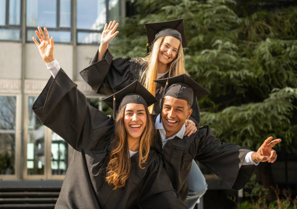 istock Group of cheerful multi ethnic students celebrating their graduation day 2200699503