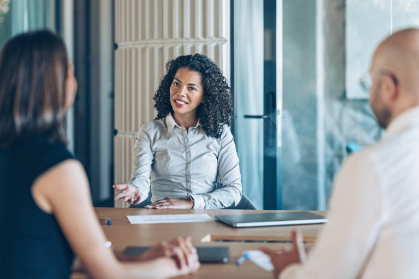 istock Smiling businesswoman talking on a meeting 2200700267