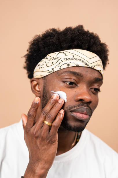 istock man applying moisturizer cream on face for skincare routine 2200701307
