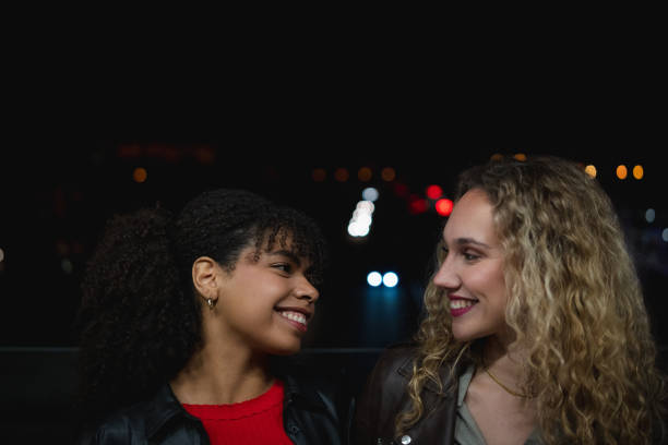 istock Two young women smiling at night 2200705563
