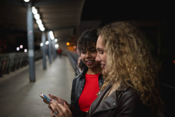 istock Young adults enjoying night out at train station 2200705565