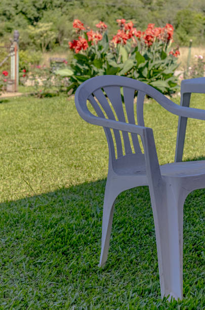 istock white plastic chair in the garden on a sunny day 2200706541