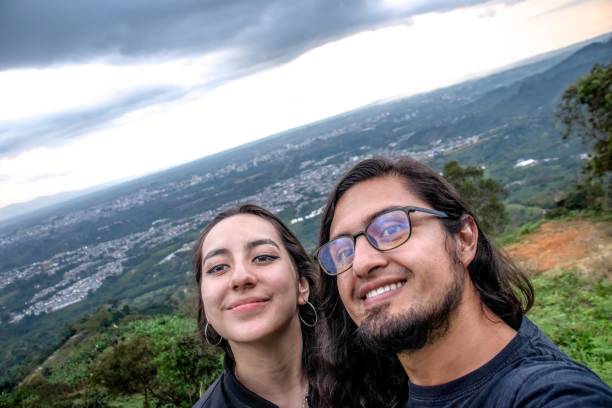 istock Smiling couple enjoying a sunset, taking a close-up selfie in a mountain setting with warm lighting. A moment of happiness and connection 2200712151