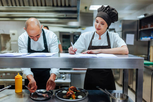 istock Chefs working together preparing gourmet meal in restaurant kitchen 2200713338