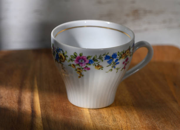 istock Delicate floral cup resting on wooden surface under soft light in cozy indoor setting 2200716979