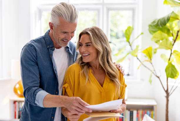 istock Couple at home reading a letter in the mail 2200718752