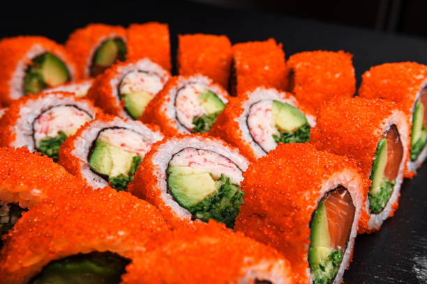 istock Delicious Fresh Sushi Rolls Presenting Exquisitely on a Black Background 2200719476