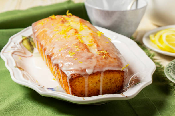 istock Aromatic lemon cake, covered with sugar icing and sprinkled with zest, served with tea. 2200727211
