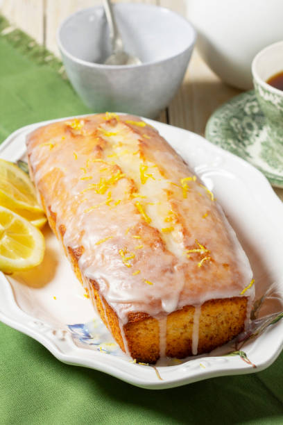 istock Aromatic lemon cake, covered with sugar icing and sprinkled with zest, served with tea. 2200727212