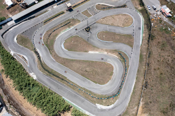 istock Distant drone capturing go-karts on winding tracks from aerial view 2200730635