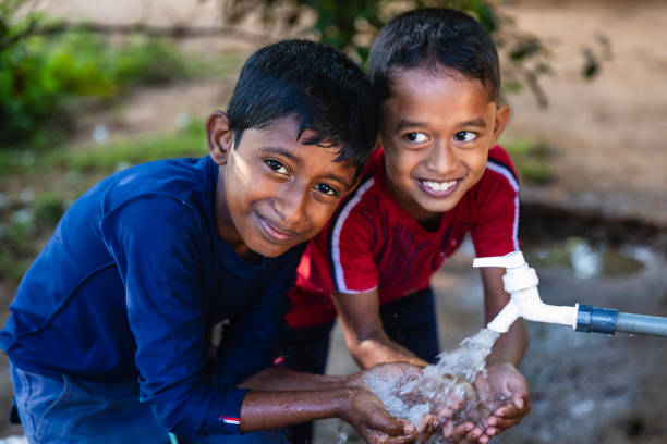 istock Sri Lankan young boys drinking a water, Ceylon 2200732626