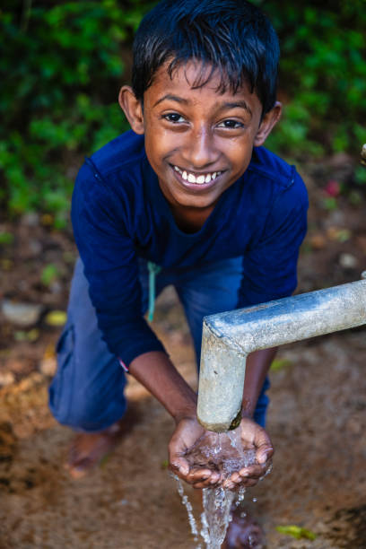 istock Sri Lankan young boys drinking a water, Ceylon 2200732727