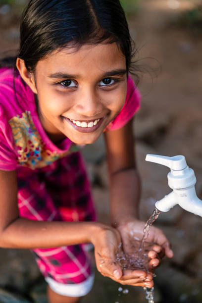 istock Sri Lankan young girl drinking a water, Ceylon 2200733080
