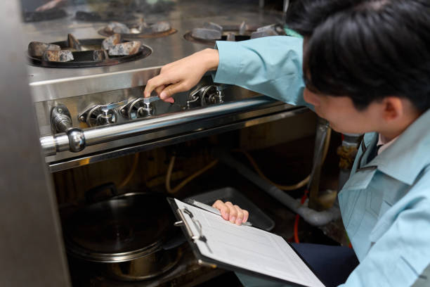 istock A man checking a gas stove at a restaurant 2200739391