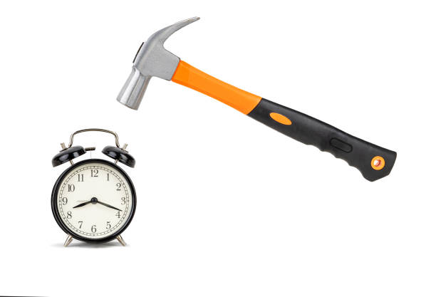 istock Metal hammer hovering above a classic alarm clock concepts like time management 2200739450