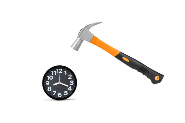 istock The metal hammer is about to smash the black clock. 2200739454