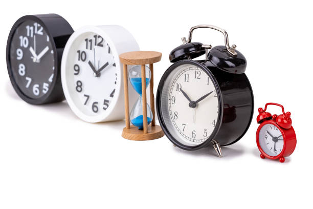 Vintage black alarm clock and modern clock on white background