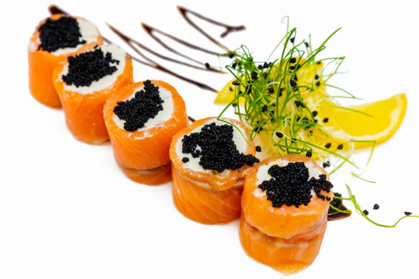 istock Rolls of sushi from red fish with black caviar on a white plate 2200743831