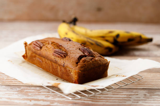 istock Banana bread loaf on wooden table. 2200747044
